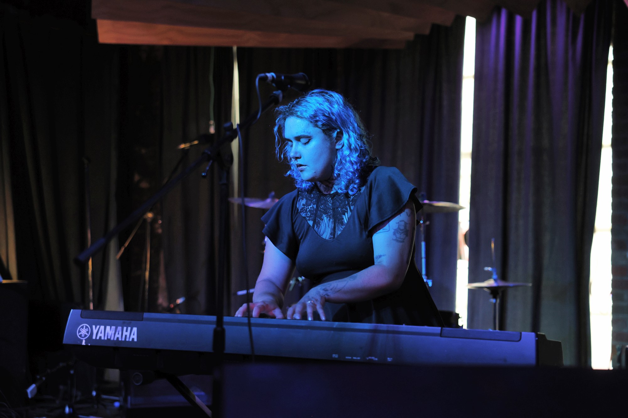 Faye performing live piano at a Quad Cities venue
